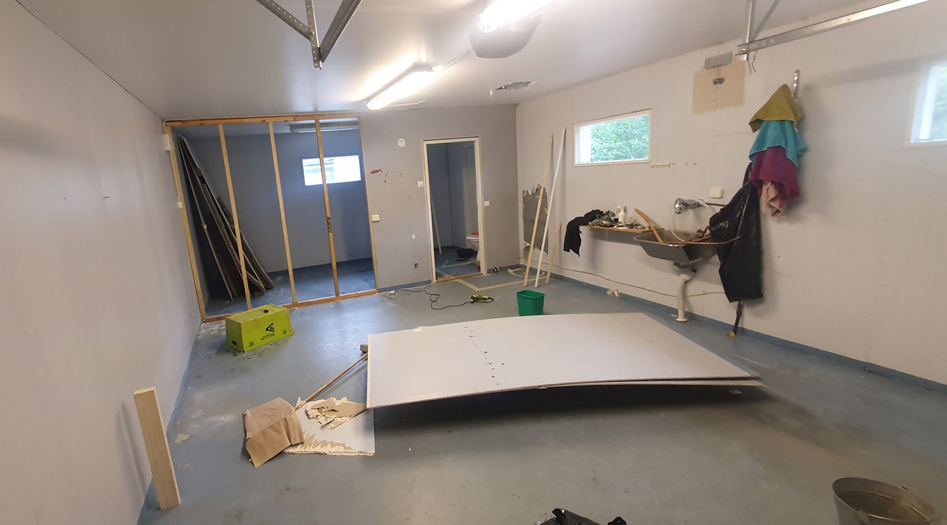 Bare garage space before the studio build began, showing the original structure