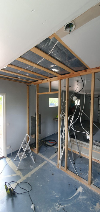 Bare garage space before the studio build began, showing the original structure